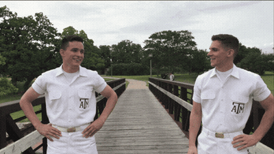 Two Men In White Shirts Saying Ain On Wooden Bridge GIF