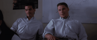 Two Men In White Shirts Sit In Front Of A White Board That Says " Car Evolution " GIF