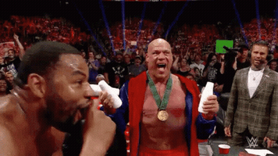 Two Men In Wrestling Ring One Wearing Medal GIF