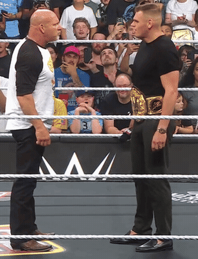 Two Men In Wrestling Ring One With Gold Belt GIF