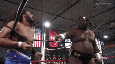 Two Men In Wrestling Ring With DPWFire Banner GIF