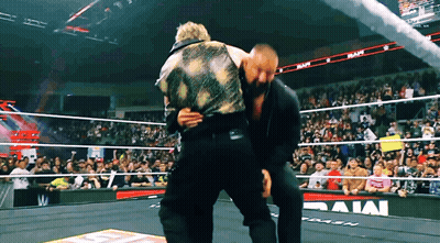 Two Men In Wrestling Ring With Rams On Wall GIF