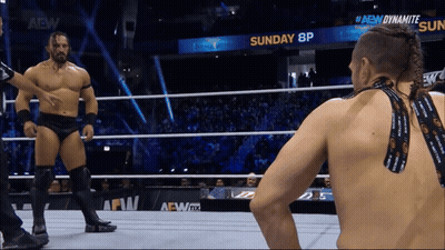 Two Men In Wrestling Ring With Sunday 8P Sign GIF