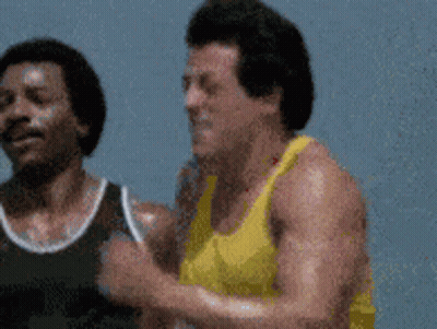 Two Men In Yellow And Black Tank Tops Running GIF