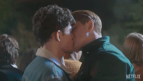 Two Men Kissing In Front Of Crowd GIF