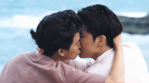 Two Men Kissing In Front Of Water GIF