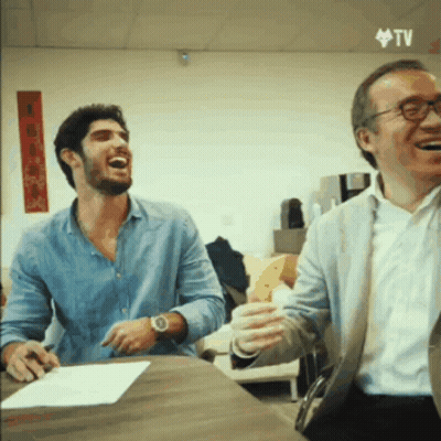 Two Men Laughing At Table GIF