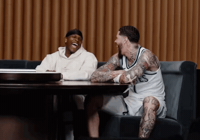 Two Men Laughing At Table One With LS Jersey GIF