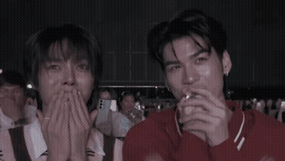 Two Men Laughing In Crowd GIF