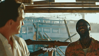 Two Men Laughing In Front Of Boat GIF