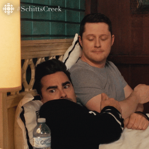 Two Men Laying In Bed With Aquafina Water GIF