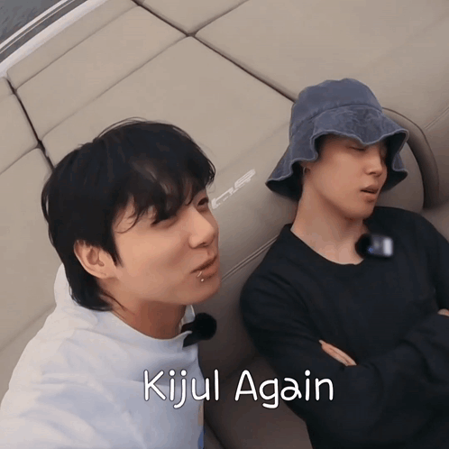 Two Men Laying On A Couch With The Words Kijul Again Written Below Them GIF