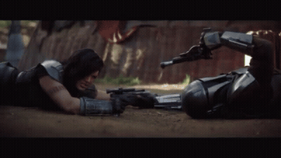 Two Men Laying On Ground Holding Guns GIF