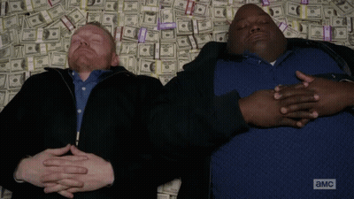 Two Men Laying On Money Pile With A And MC GIF