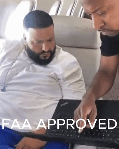 Two Men Looking At A Laptop With The Words Faa Approved Written On The Bottom GIF
