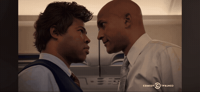 Two Men Looking At Each Other Comedy Central Logo GIF