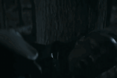 Two Men Looking At Each Other In Dark Room GIF