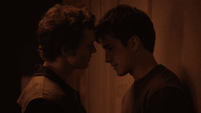 Two Men Looking At Each Other In The Dark GIF