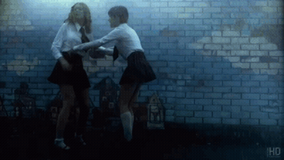 Two Men Looking At Each Other In The Dark GIF