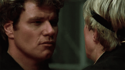 Two Men Looking At Each Other One With Headband GIF