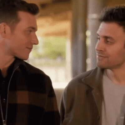 Two Men Looking At Each Other Smiling GIF