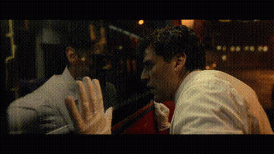 Two Men Looking At Each Other Through Window GIF
