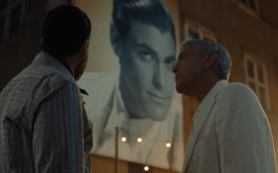 Two Men Looking At Man In White Suit GIF