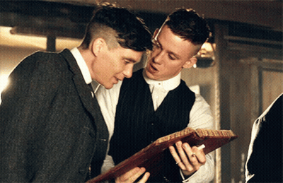 Two Men Looking At Paper Together GIF