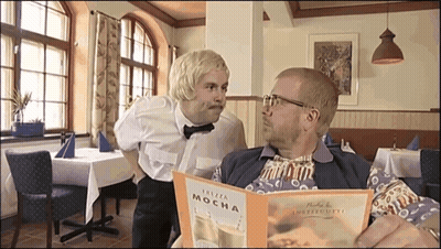 Two Men Looking At Plaza Mocha Menu GIF
