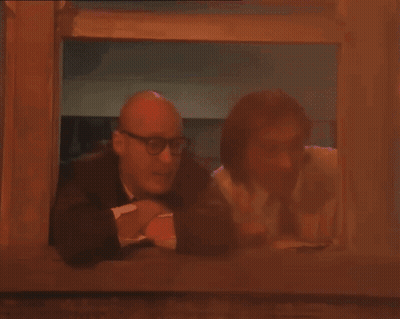 Two Men Looking Out Window Purple Light GIF