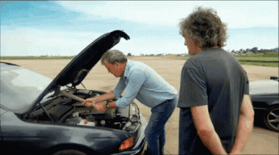 Two Men Looking Under The Hood Of A Car With The Hood Open GIF