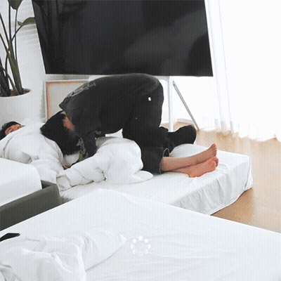 Two Men Lying On Bed With Feet Up GIF