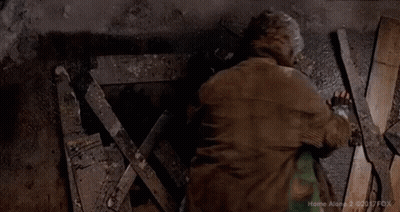Two Men Lying On Ground Covered In Paint And Gloves GIF
