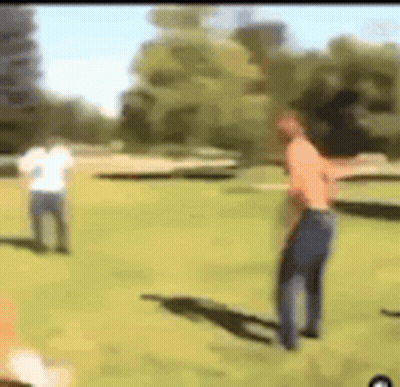 Two Men On A Grass Field GIF