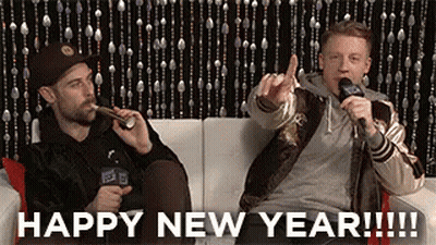 Two Men On Couch One Giving Middle Finger GIF
