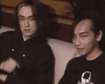 Two Men On Couch One Pointing At Camera GIF