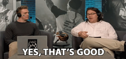Two Men On Couch One Wearing Care Stand Up Shirt GIF