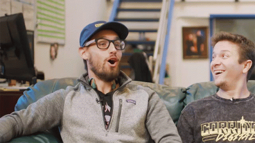 Two Men On Couch One Wearing Current Digital Shirt GIF