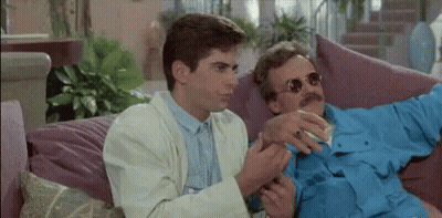 Two Men On Couch Talking One Smoking GIF