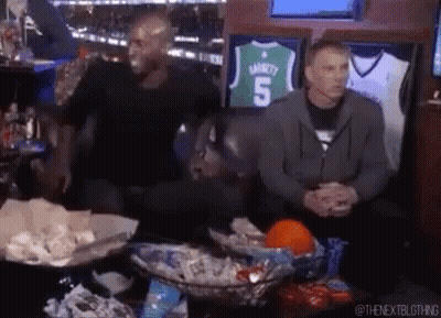 Two Men On Couch With Basketball Jersey Number 5 GIF