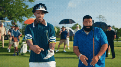 Two Men On Golf Course One With Number 21 On Sleeve GIF
