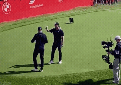 Two Men On Golf Course With Cameraman GIF
