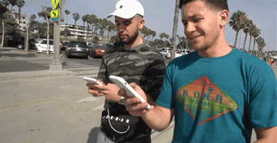 Two Men On Phones One Kona Hawaii Shirt GIF