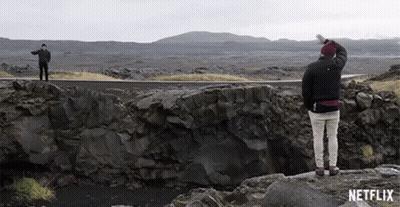 Two Men On Rocky Cliff With Netflix Logo GIF