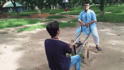 Two Men On Seesaw, One In Blue Shirt GIF