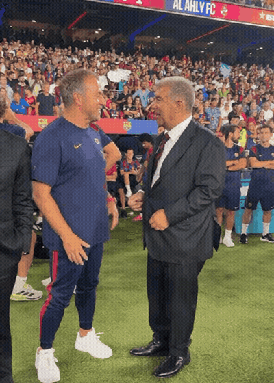 Two Men On Soccer Field With Al Ahly FC Banner GIF