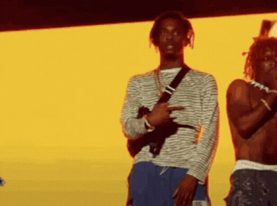 Two Men on Stage One Holding Gun