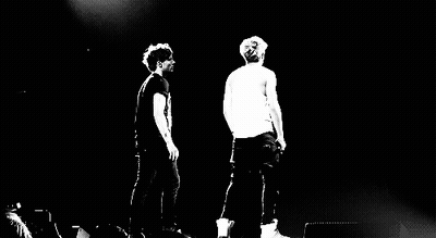 Two Men On Stage With Microphones GIF