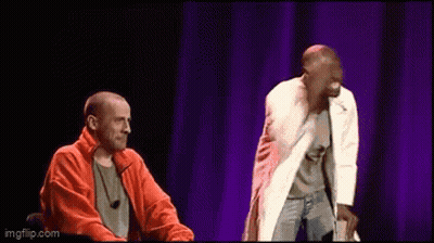 Two Men On Stage With Purple Curtain GIF