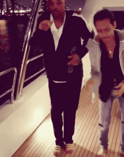 Two Men On Wooden Deck One Holding Beer GIF